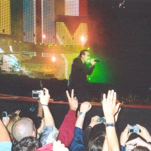 Bono kneels to the crowd