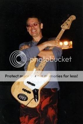 Adam_holding_his_bass_and_smiling.jpg