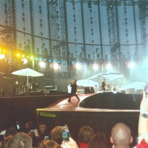 Bono coming down under a sky of coloured lights