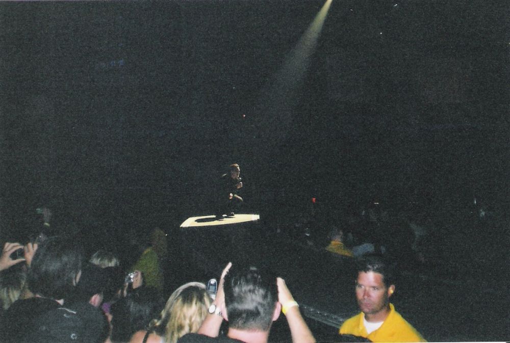 Bono kneeling spotlight